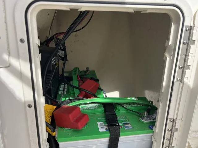 Slide: The Image of Battery compartment of a 2018 Key West 186DC boat with green batteries and wiring. - 11
