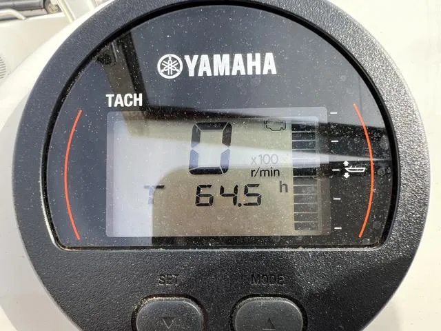 Slide: The Image of Yamaha tachometer displaying 64.5 hours on a 2018 Key West 186DC boat. - 14