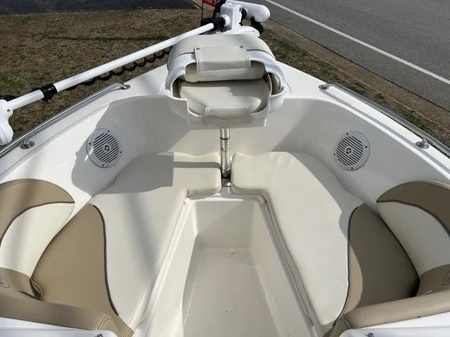 Slide: The Image of 2018 Key West 186DC boat interior with beige seating and speakers. - 8