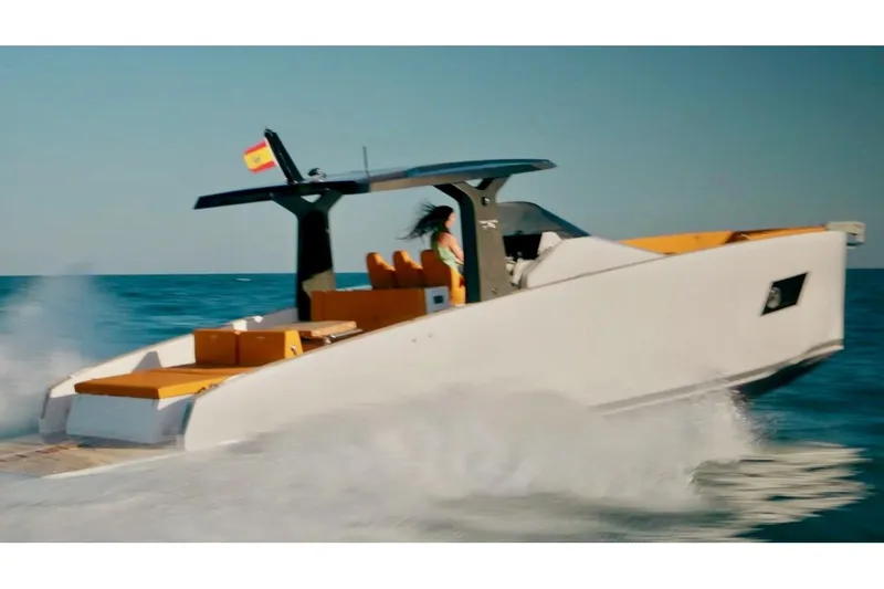 Slide: The Image of 2024 Tesoro T40 Inboard yacht cruising on open water with Spanish flag. - 10