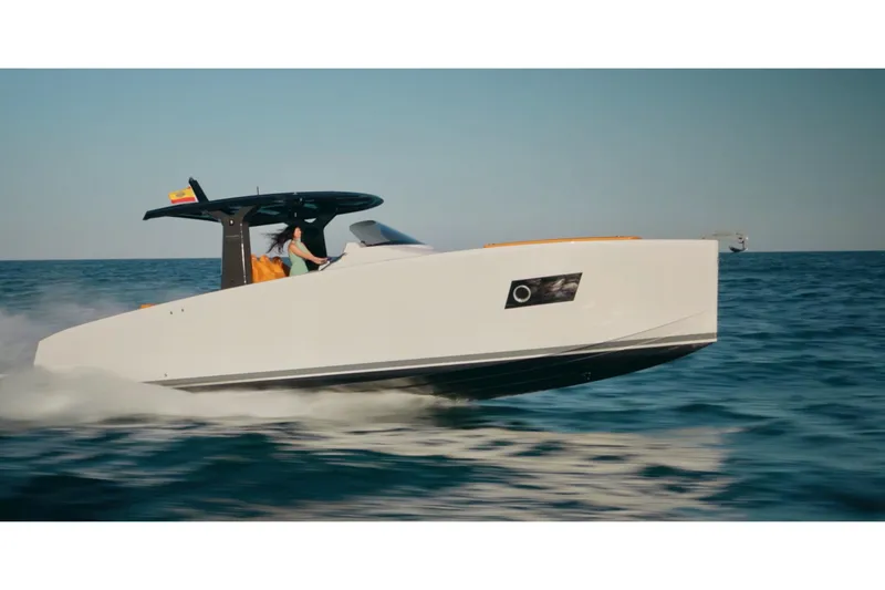 Slide: The Image of 2024 Tesoro T40 Inboard boat cruising on open water under clear blue sky. - 12