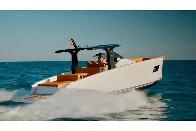 Slide: The Image of 2024 Tesoro T40 Inboard yacht cruising on open water, showcasing sleek design and luxury features. - 13