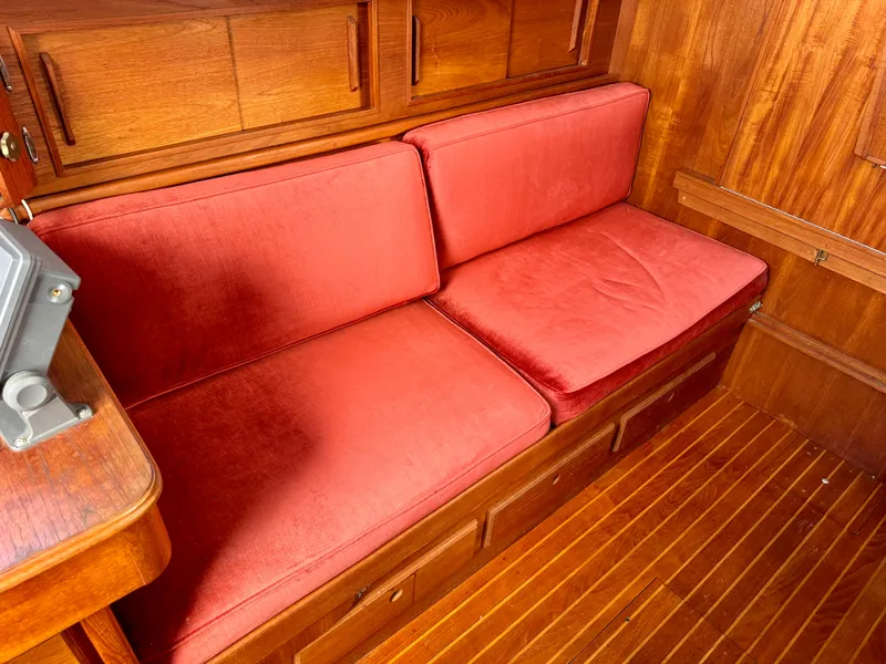 Slide: The Image of Red cushioned seating in 1981 Bristol 29.9 boat interior with wooden paneling. - 13
