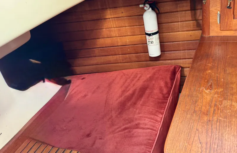 Slide: The Image of 1981 Bristol 29.9 interior with red cushion and mounted fire extinguisher. - 15