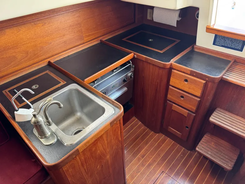 Slide: The Image of 1981 Bristol 29.9 yacht kitchen with wooden cabinetry, sink, and stove. - 16