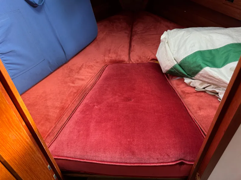 Slide: The Image of Interior cabin of a 1981 Bristol 29.9 sailboat with red cushions. - 17