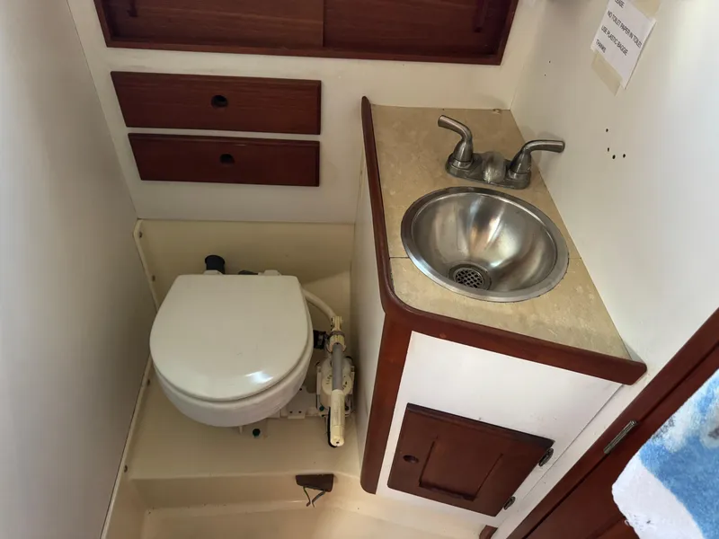 Slide: The Image of 1981 Bristol 29.9 yacht bathroom with sink, toilet, and wooden cabinetry. - 18
