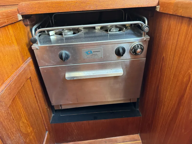 Slide: The Image of 1981 Bristol 29.9 stove with dual burners and oven in wooden cabinetry. - 20