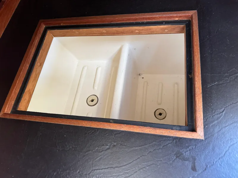 Slide: The Image of 1981 Bristol 29.9 sink with wooden trim, dual compartments, and black countertop. - 22