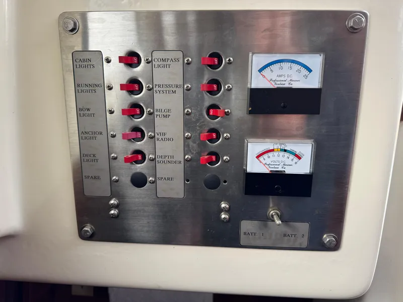 Slide: The Image of Control panel of a 1981 Bristol 29.9 boat with switches and gauges. - 23