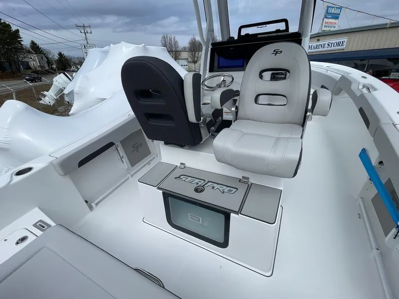 Slide: The Image of 2025 Sea Pro 245 Sandbar boat interior with modern seating and control panel. - 10