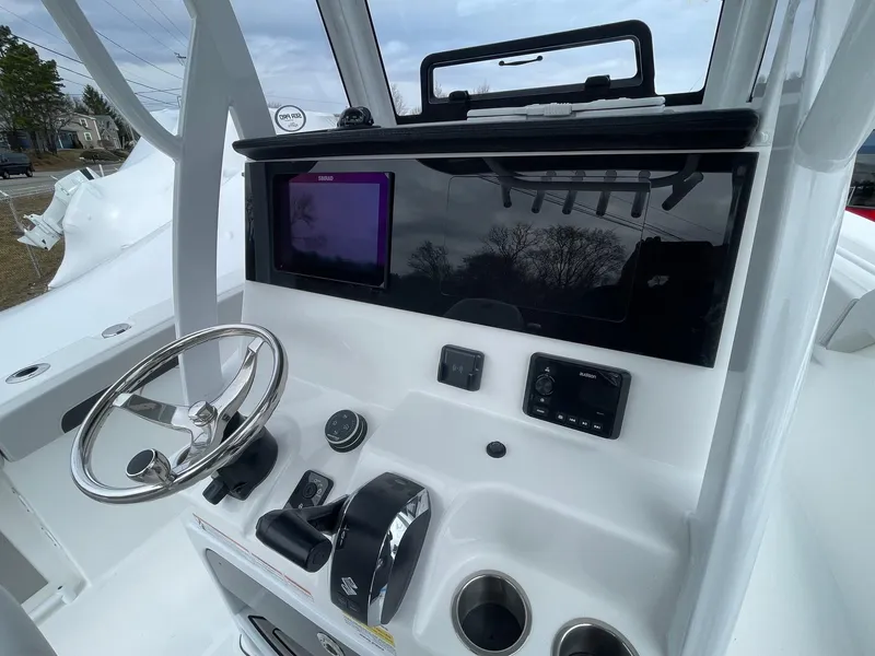 Slide: The Image of 2025 Sea Pro 245 Sandbar boat dashboard with steering wheel and electronic controls. - 12