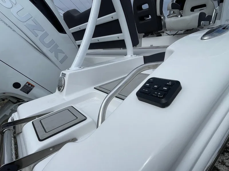 Slide: The Image of 2025 Sea Pro 245 Sandbar boat deck with Suzuki engine and control panel. - 19