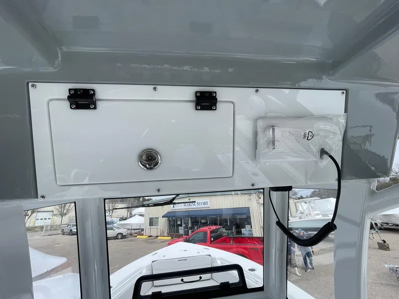 Slide: The Image of 2025 Sea Pro 245 Sandbar boat interior with storage compartment and wiring. - 21