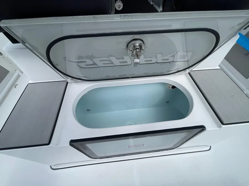 Slide: The Image of Livewell compartment on 2025 Sea Pro 245 Sandbar boat, open lid view. - 23
