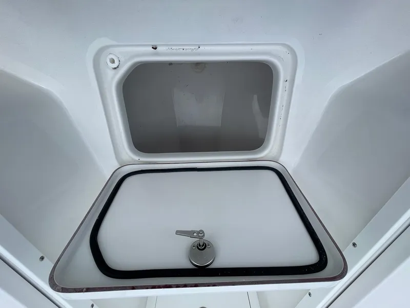 Slide: The Image of 2025 Sea Pro 245 Sandbar boat storage compartment with secure latch. - 25
