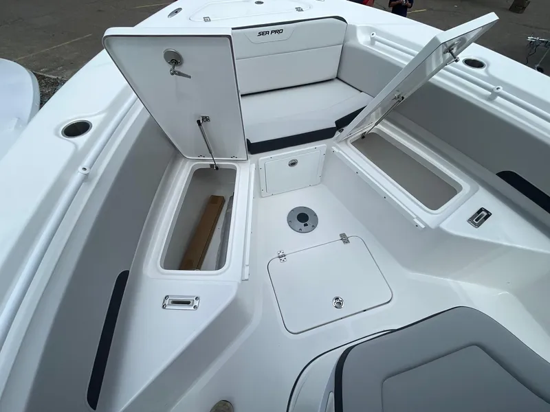 Slide: The Image of 2025 Sea Pro 245 Sandbar boat interior with open storage compartments and seating. - 28