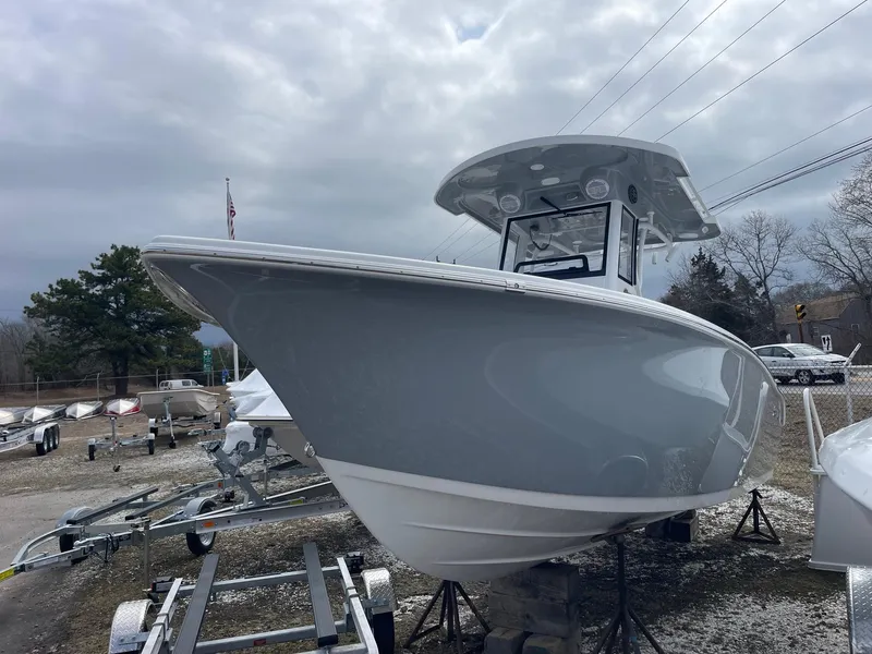 Slide: The Image of 2025 Sea Pro 245 Sandbar boat on display, cloudy sky background. - 3