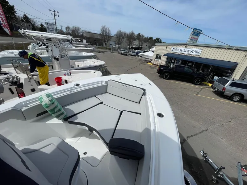 Slide: The Image of 2025 Sea Pro 245 Sandbar boat displayed at a marine store parking lot. - 32