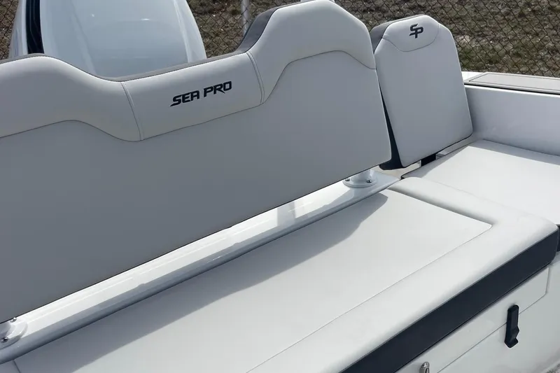 Slide: The Image of 2025 Sea Pro 245 Sandbar boat seating with logo, featuring sleek white upholstery. - 37