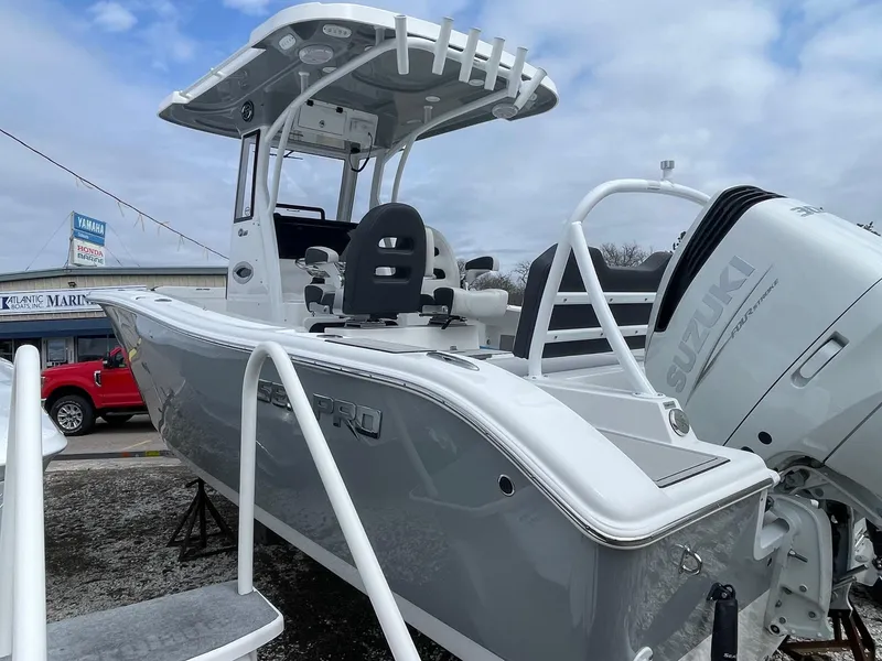 Slide: The Image of 2025 Sea Pro 245 Sandbar boat with Suzuki engine, displayed outdoors. - 4