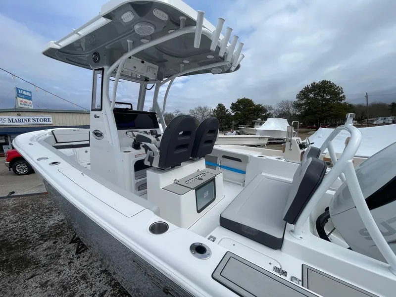 Slide: The Image of 2025 Sea Pro 245 Sandbar boat with modern console and seating, displayed outdoors. - 5