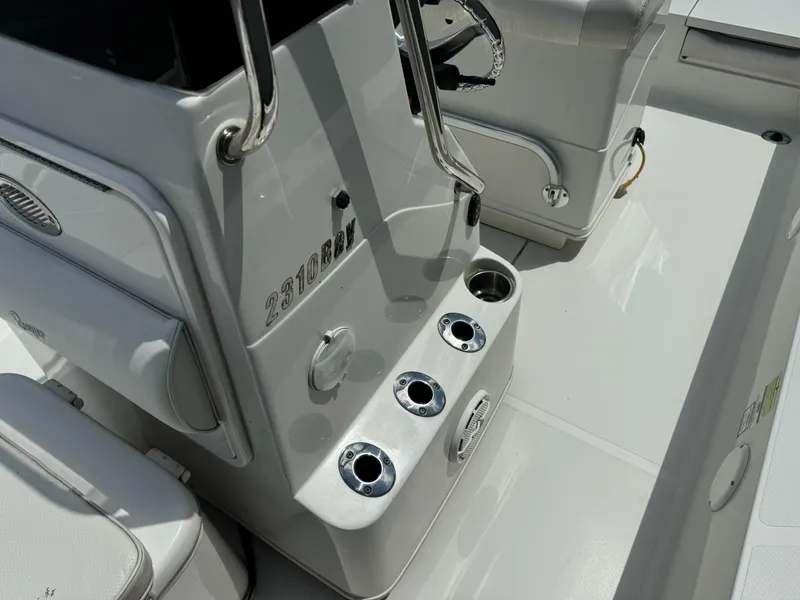 Slide: The Image of 2010 Ranger 2310 boat console with cup holders and storage compartments. - 10