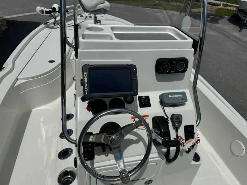 Slide: The Image of 2010 Ranger 2310 boat console with steering wheel, electronics, and controls. - 12