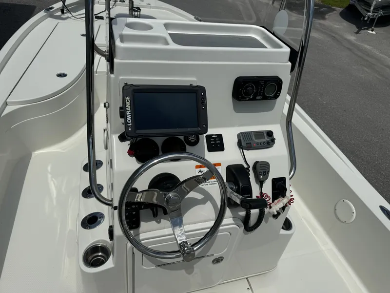 Slide: The Image of 2010 Ranger 2310 boat console with steering wheel, navigation system, and controls. - 13