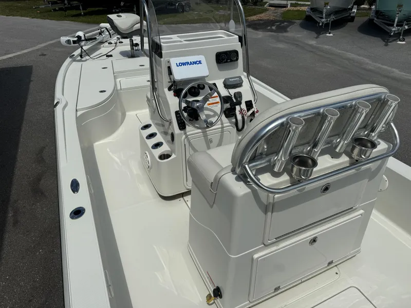 Slide: The Image of 2010 Ranger 2310 boat interior with steering console and rod holders. - 15
