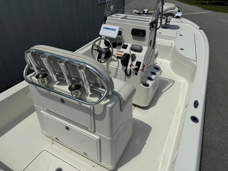 Slide: The Image of 2010 Ranger 2310 boat interior with steering console and rod holders. - 16