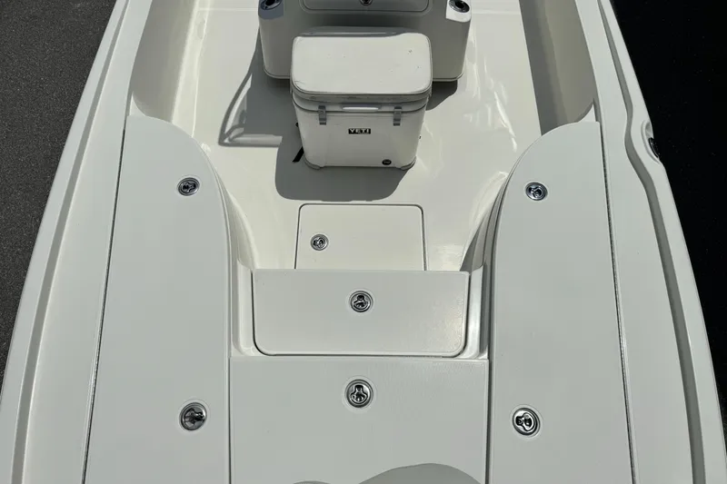 Slide: The Image of 2010 Ranger 2310 boat deck with storage compartments and cooler. - 17