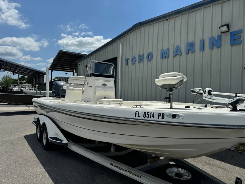 Slide: The Image of 2010 Ranger 2310 boat on trailer at Toho Marine, under clear blue sky. - 2