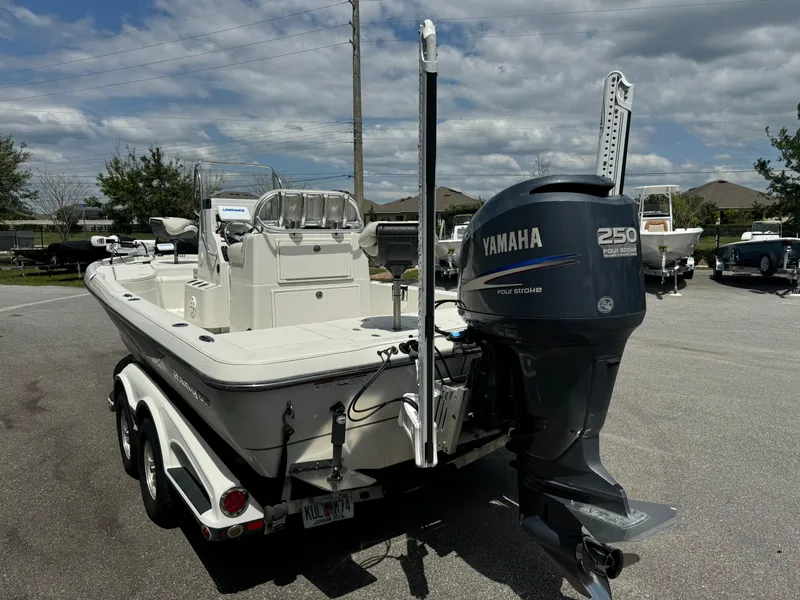 Slide: The Image of 2010 Ranger 2310 boat with Yamaha 250 engine on a trailer, parked outdoors. - 21