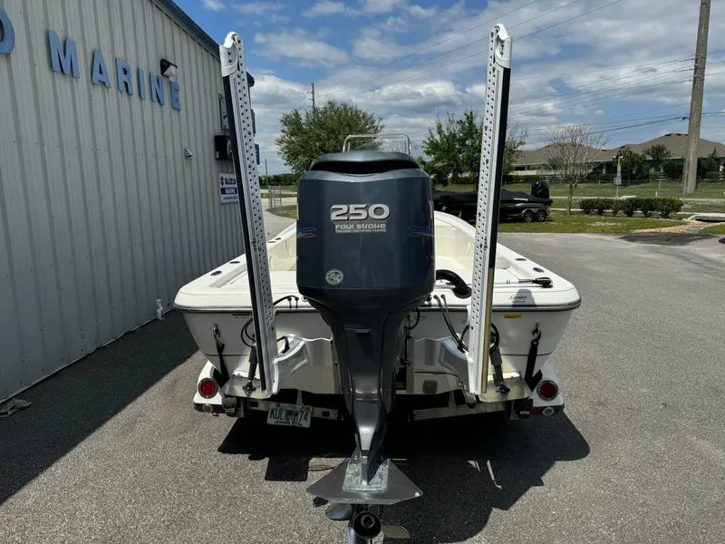 Slide: The Image of 2010 Ranger 2310 boat with 250 horsepower engine, parked outside a marine facility. - 22