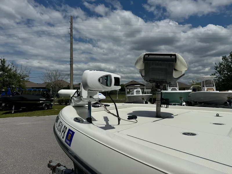 Slide: The Image of 2010 Ranger 2310 boat with mounted equipment under a partly cloudy sky. - 4