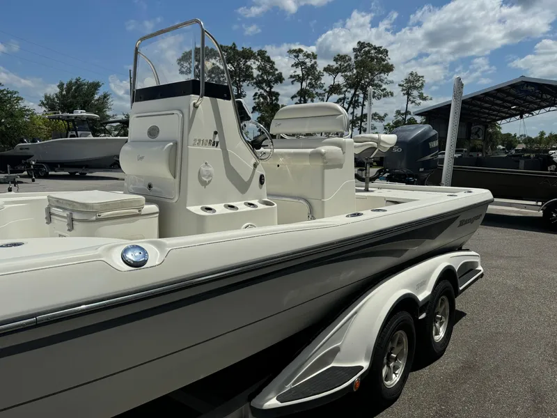 Slide: The Image of 2010 Ranger 2310 boat on trailer under a partly cloudy sky. - 5