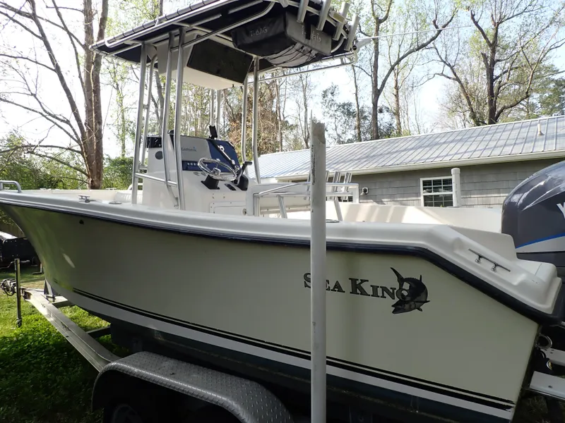 Slide: The Image of 2006 Sea King 210CC boat on trailer, parked outdoors near a house. - 12