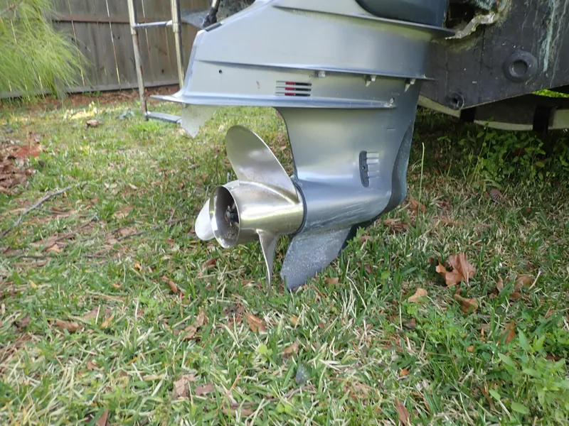 Slide: The Image of Outboard motor of a 2006 Sea King 210CC on grass, showing propeller detail. - 16