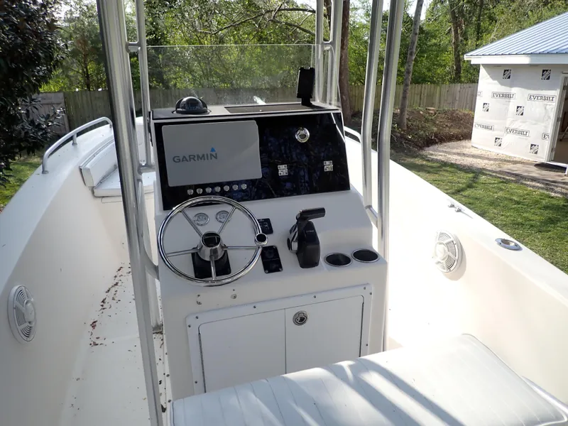 Slide: The Image of 2006 Sea King 210CC boat console with Garmin navigation system, steering wheel, and controls. - 4