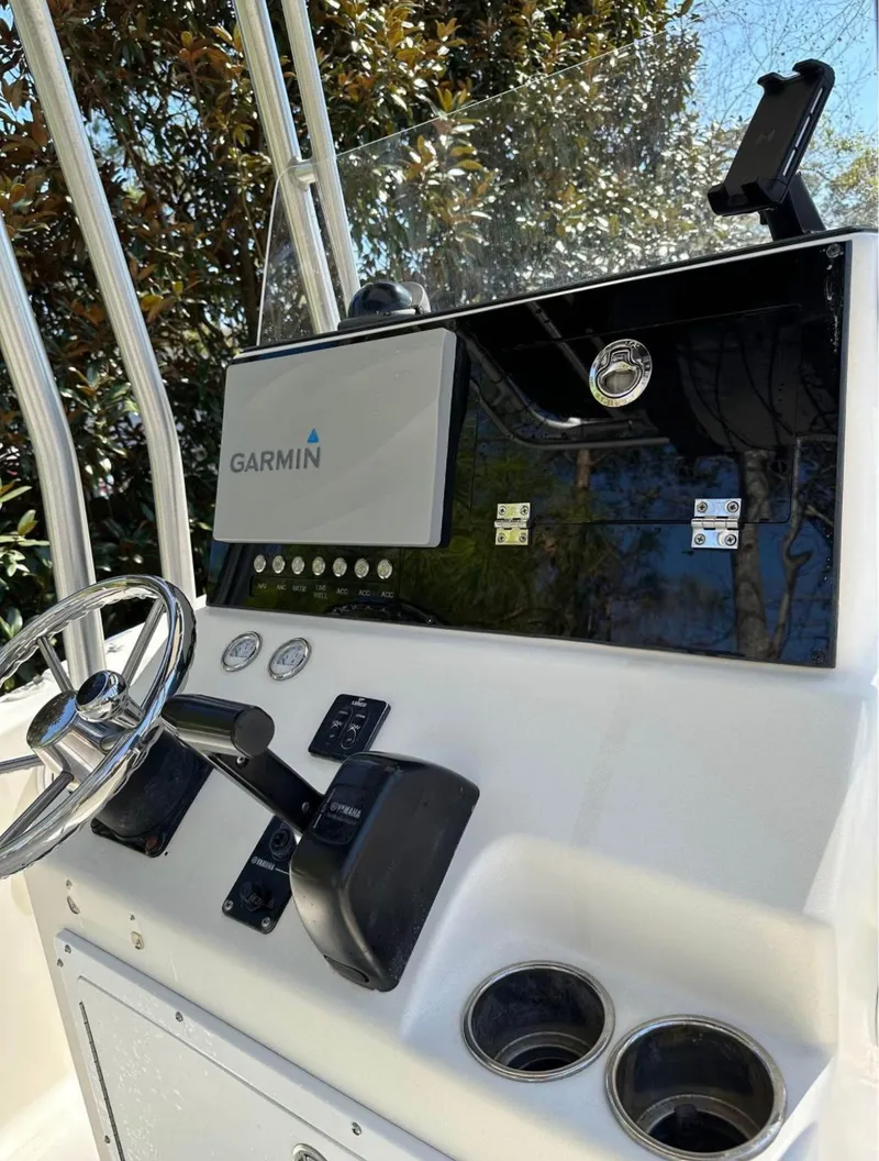 Slide: The Image of 2006 Sea King 210CC boat dashboard with Garmin navigation system and steering wheel. - 6