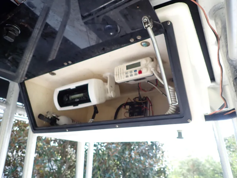Slide: The Image of 2006 Sea King 210CC boat electronics compartment with radio and wiring. - 7