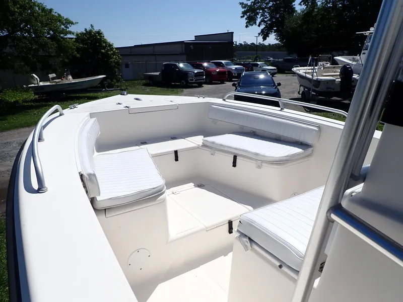 Slide: The Image of 2006 Sea King 210CC boat with white seating in a marina setting. - 8
