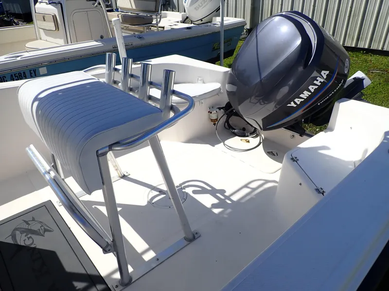 Slide: The Image of 2006 Sea King 210CC boat with Yamaha outboard motor, featuring a sleek white interior. - 9