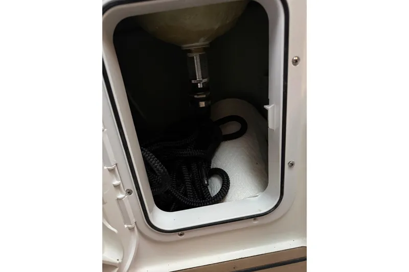 Slide: The Image of Storage compartment of 2022 Oceania 23WA boat with black rope inside. - 16