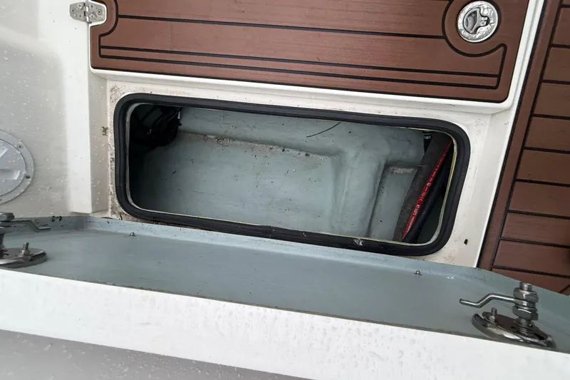 Slide: The Image of Open storage compartment on 2022 Oceania 23WA boat with wooden deck accents. - 17