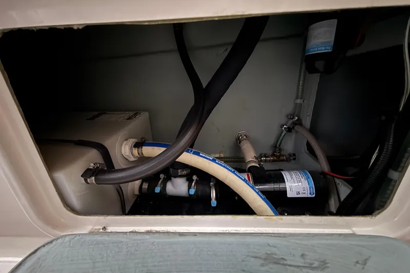 Slide: The Image of Interior view of 2022 Oceania 23WA boat's plumbing system with hoses and pump. - 18