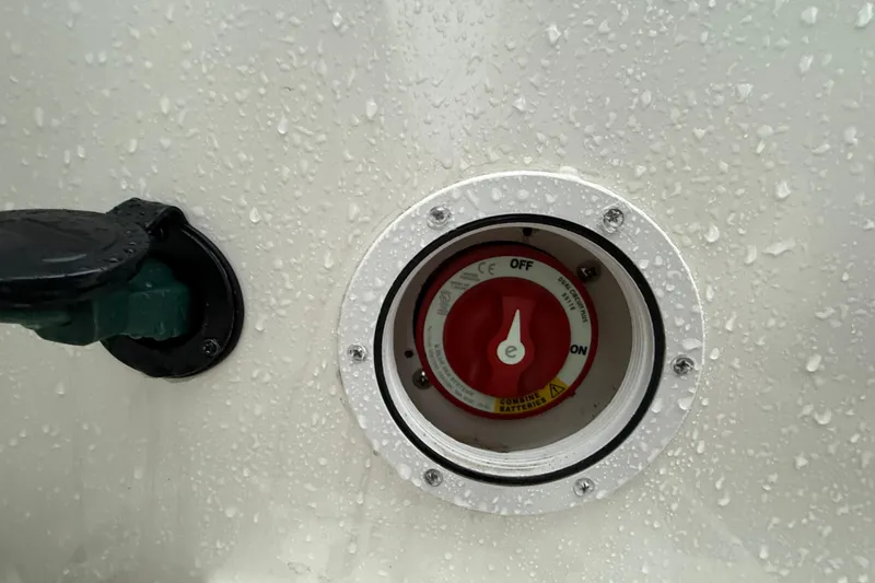 Slide: The Image of Close-up of a 2022 Oceania 23WA boat switch with water droplets. - 19