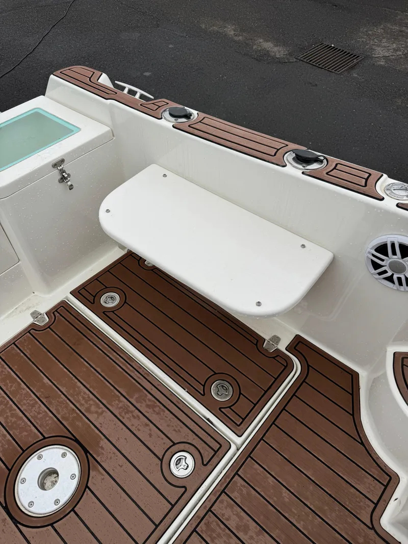 Slide: The Image of Oceania 23WA 2022 boat deck with wooden flooring and foldable seat. - 2