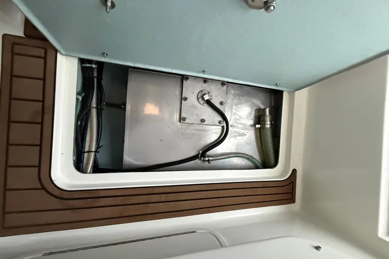 Slide: The Image of Compartment view of 2022 Oceania 23WA boat with visible hoses and fittings. - 20